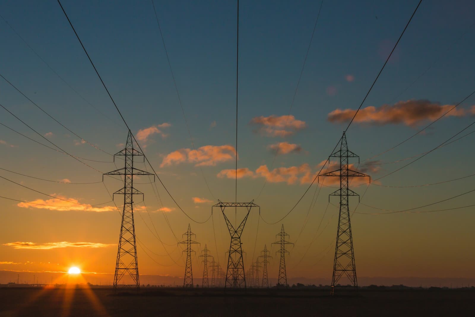 Power lines and pylons at sunset